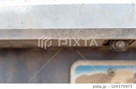 Backup camera on a vehicle obscured with dirt, mud, and dust so that the driver cannot see.  104370975