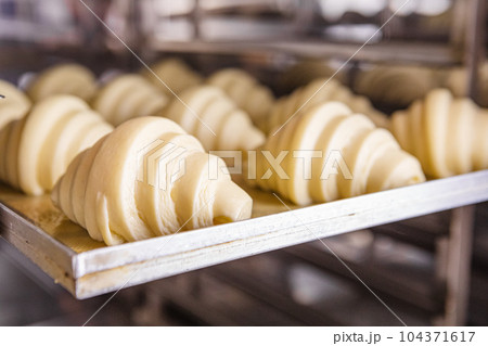 Oven-ready proofed croissant dough Oven-ready proofed croissant dough 104371617