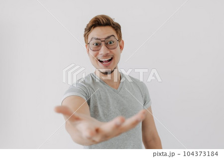 Happy Man with colored hair presenting product. Concept of advertisement. 104373184