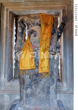 An ancient decapitated stone sculpture of Buddha in a Cambodian temple. An ancient decapitated stone sculpture of Buddha in a Cambodian temple. 104373231