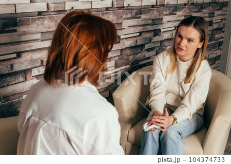 Therapist talk to his patient. Woman psychologist talking to patient. Therapist talk to his patient. Woman psychologist talking to patient. 104374733