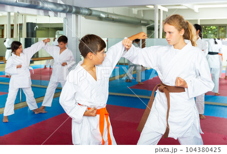 Teenager children practicing new self defense moves 104380425