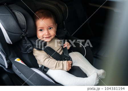 happy baby sitting in infant car seat, safety chair travelling happy baby sitting in infant car seat, safety chair travelling 104381194