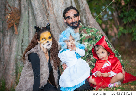 Real family having fun while using costumes of the Little red riding hood tale in Halloween. Real family having fun while using costumes of the Little red riding hood tale in Halloween. 104381713