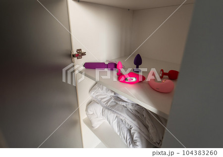 Lots of different vibrators in the closet. Personal collection of sex toys.  104383260