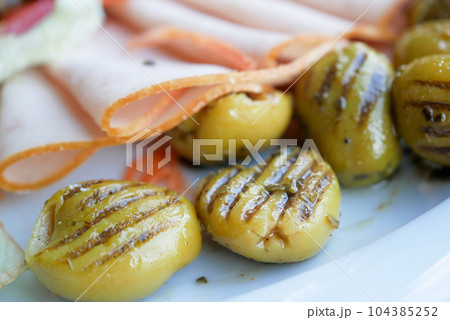 Turkish Grilled olives and salami meat on a plate  104385252
