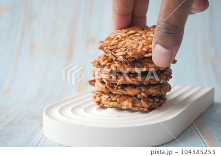 close up of sesame cookies on wooden table  104385253