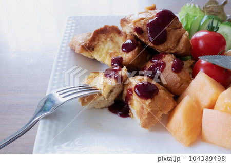 バゲットで作ったふわふわフレンチトーストにジャムをかけて 104389498