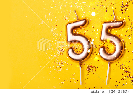 55 years celebration. Greeting banner. Gold candles in the form of number forty on yellow background with confetti. 55 years celebration. Greeting banner. Gold candles in the form of number forty on yellow background with confetti. 104389622