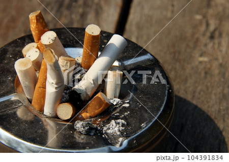 Tobaccos in metal ashtray. Tobaccos in metal ashtray. 104391834