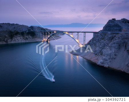 Bridge over the sea at sunset. Aerial view of modern Krk bridge Bridge over the sea at sunset. Aerial view of modern Krk bridge 104392721