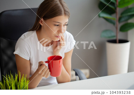 Unhappy young worker suffering from aching teeth in the office Unhappy young worker suffering from aching teeth in the office 104393238