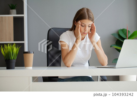 Woman massaging temples, suffering from headache after computer work Woman massaging temples, suffering from headache after computer work 104393242