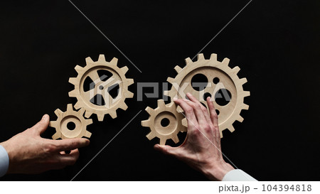 Wooden mechanisms on a black background. Black chalk board. Wooden mechanisms on a black background. Black chalk board. 104394818