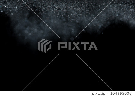 Explosion metallic black glitter sparkle. Dark Glitter powder spark blink celebrate, blur foil explode in air, fly throw black glitters particle. Black background isolated, selective focus Blur bokeh 104395606