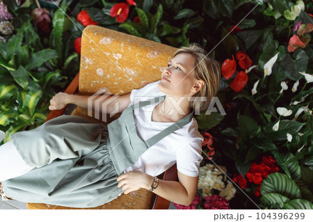 Small business entrepreneur owner,happy woman sitting with flowers at florist shop service job. Portrait of caucasian girl successful owner environment, top view 104396299
