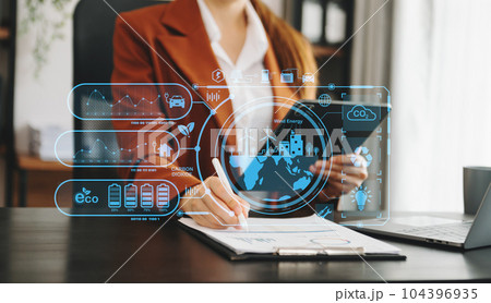Business working with reduce CO2 concept with icons, global warming such as reforest green factory recycle and zero carbon dioxide emission concept. with VR icon at office. Business working with reduce CO2 concept with icons, global warming such as reforest green factory recycle and zero carbon dioxide emission concept. with VR icon at office. 104396935