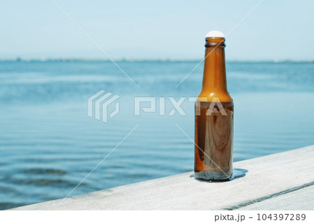 refreshing beer bottle on the pier refreshing beer bottle on the pier 104397289