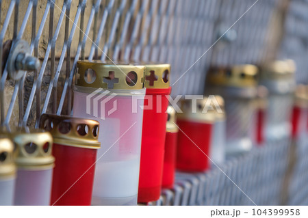 jars with candles on the wall on the day of remembrance of the victims. 104399958