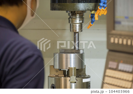 The machine operator working with CNC milling machine. The machine operator working with CNC milling machine. 104403966
