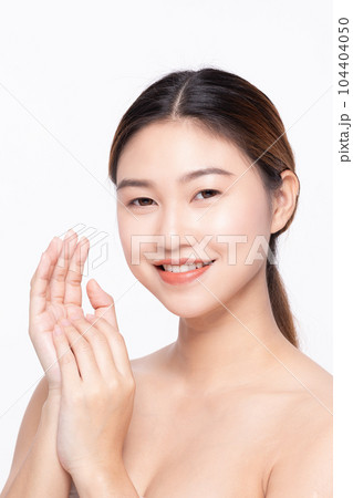 Beautiful Asian woman touching soft cheek smile with clean and fresh skin Happiness and cheerful with positive emotional,isolated on white background,Beauty Self Care and Cosmetics Concept 104404050