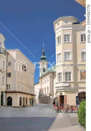 View into Linzer Gasse of Salzburg in Austria. Main pedestrian artery through the historical district on the right side of the river Salzach, with houses from 14th century and the St Sebastian church. View into Linzer Gasse of Salzburg in Austria. Main pedestrian artery through the historical district on the right side of the river Salzach, with houses from 14th century and the St Sebastian church. 104406776