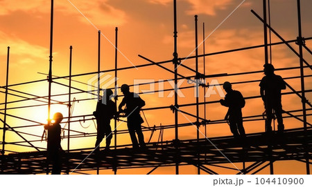 Silhouette of construction worker checking project at building site background. 104410900