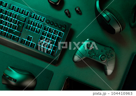 Blue lit keyboard with various wireless devices Blue lit keyboard with various wireless devices 104410963