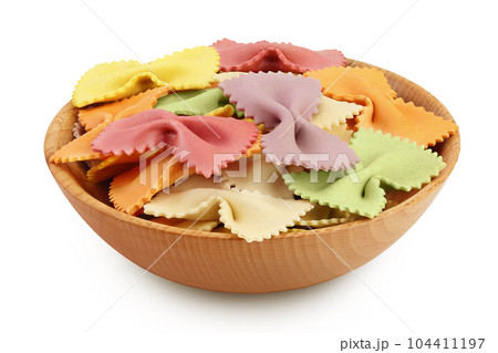 colorful farfalle pasta in wooden bowl isolated on white background with full depth of field 104411197