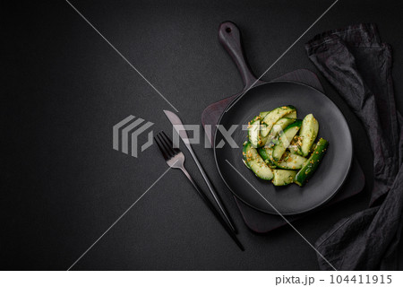 Delicious juicy cucumber cut into large slices with salt, spices and french mustard 104411915