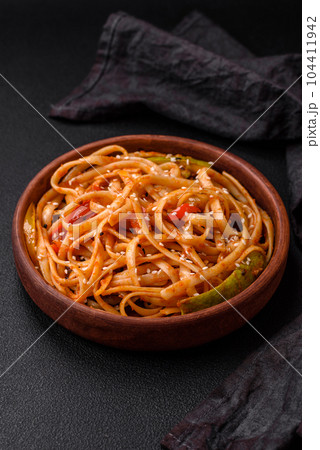 Delicious asian udon dish with vegetables, mushrooms, salt and spices 104411942