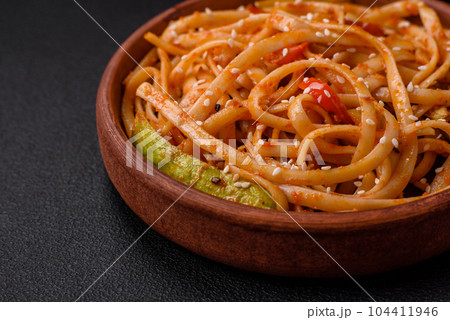 Delicious asian udon dish with vegetables, mushrooms, salt and spices 104411946
