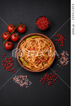 Delicious asian udon dish with vegetables, mushrooms, salt and spices 104411954