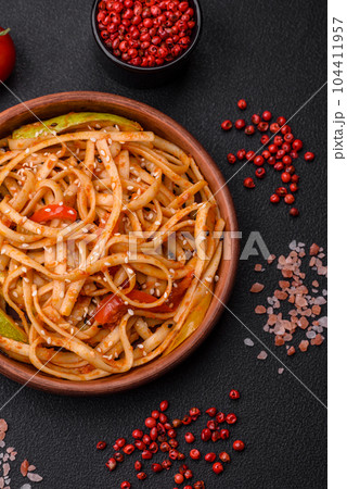 Delicious asian udon dish with vegetables, mushrooms, salt and spices 104411957