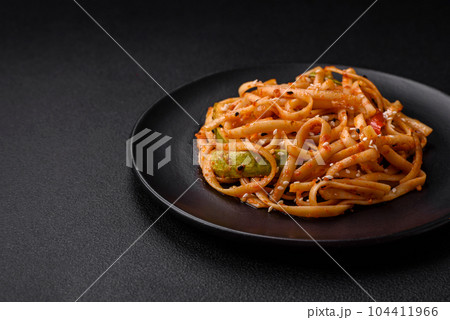 Delicious asian udon dish with vegetables, mushrooms, salt and spices 104411966