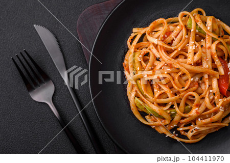 Delicious asian udon dish with vegetables, mushrooms, salt and spices Delicious asian udon dish with vegetables, mushrooms, salt and spices 104411970