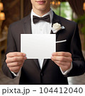Man in suit, a Groom showing a white card in hands. Groomsman card mock-up 104412040