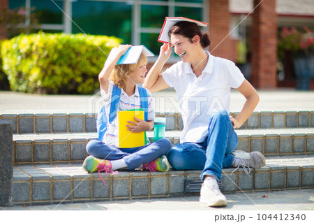 School pick up. Mother and kids after school. 104412340