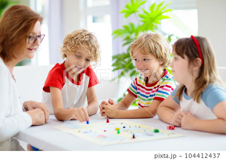 Family playing board game. Kids play. 104412437