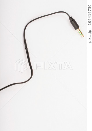 3.5mm headphone jack with wire lies on a white background isolate 104414750