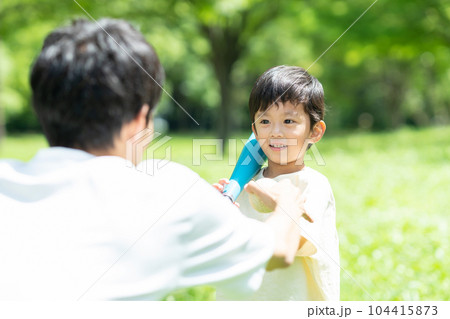 公園でボール遊びをする親子 104415873