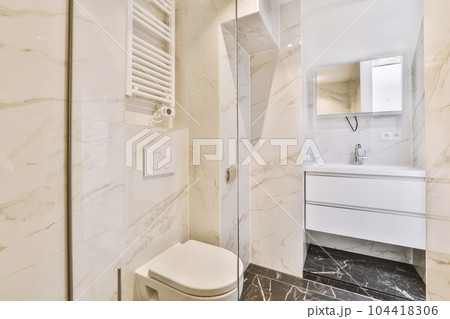 a modern bathroom with marble flooring and white walls, along with a toilet in the shower stall is next to the sink a modern bathroom with marble flooring and white walls, along with a toilet in the shower stall is next to the sink 104418306