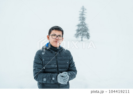 man tourist Visiting in Biei, Traveler in Sweater sightseeing Christmas tree with Snow in winter season. landmark and popular for attractions in Hokkaido, Japan. Travel and Vacation concept 104419211