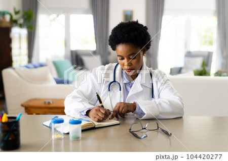 African american female doctor making video call in bright room 104420277
