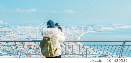 Woman tourist Visiting in Hakodate, Traveler in Sweater sightseeing view from Hakodate mountain with Snow in winter. landmark and popular for attractions in Hokkaido, Japan.Travel and Vacation concept Woman tourist Visiting in Hakodate, Traveler in Sweater sightseeing view from Hakodate mountain with Snow in winter. landmark and popular for attractions in Hokkaido, Japan.Travel and Vacation concept 104420583