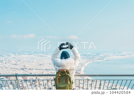 Woman tourist Visiting in Hakodate, Traveler in Sweater sightseeing view from Hakodate mountain with Snow in winter. landmark and popular for attractions in Hokkaido, Japan.Travel and Vacation concept Woman tourist Visiting in Hakodate, Traveler in Sweater sightseeing view from Hakodate mountain with Snow in winter. landmark and popular for attractions in Hokkaido, Japan.Travel and Vacation concept 104420584