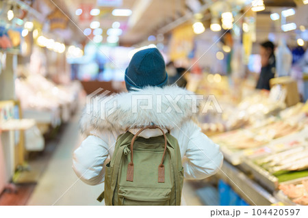 Woman tourist Visiting in Hakodate, Traveler in Sweater sightseeing Asaichi Morning Market Hakodate in winter. landmark and popular for attractions in Hokkaido, Japan. Travel and Vacation concept Woman tourist Visiting in Hakodate, Traveler in Sweater sightseeing Asaichi Morning Market Hakodate in winter. landmark and popular for attractions in Hokkaido, Japan. Travel and Vacation concept 104420597