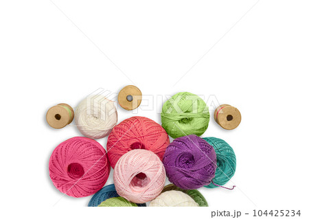 Balls of wool yarn with wooden bobbin with threads on white isolated background. Concept of knitting, sewing. Copy space Balls of wool yarn with wooden bobbin with threads on white isolated background. Concept of knitting, sewing. Copy space 104425234