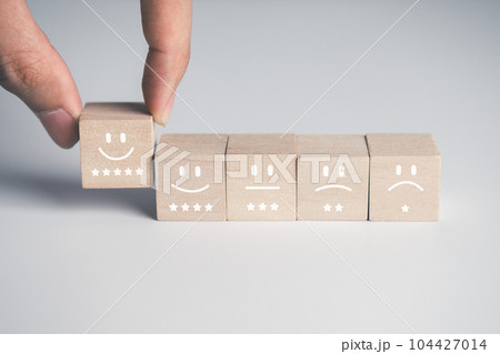 Wooden block of survey rating icon for customer satisfaction scores. customer satisfaction concept. 104427014