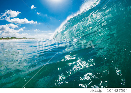 Turquoise waves in ocean. Breaking wave ideal for surfing 104427594